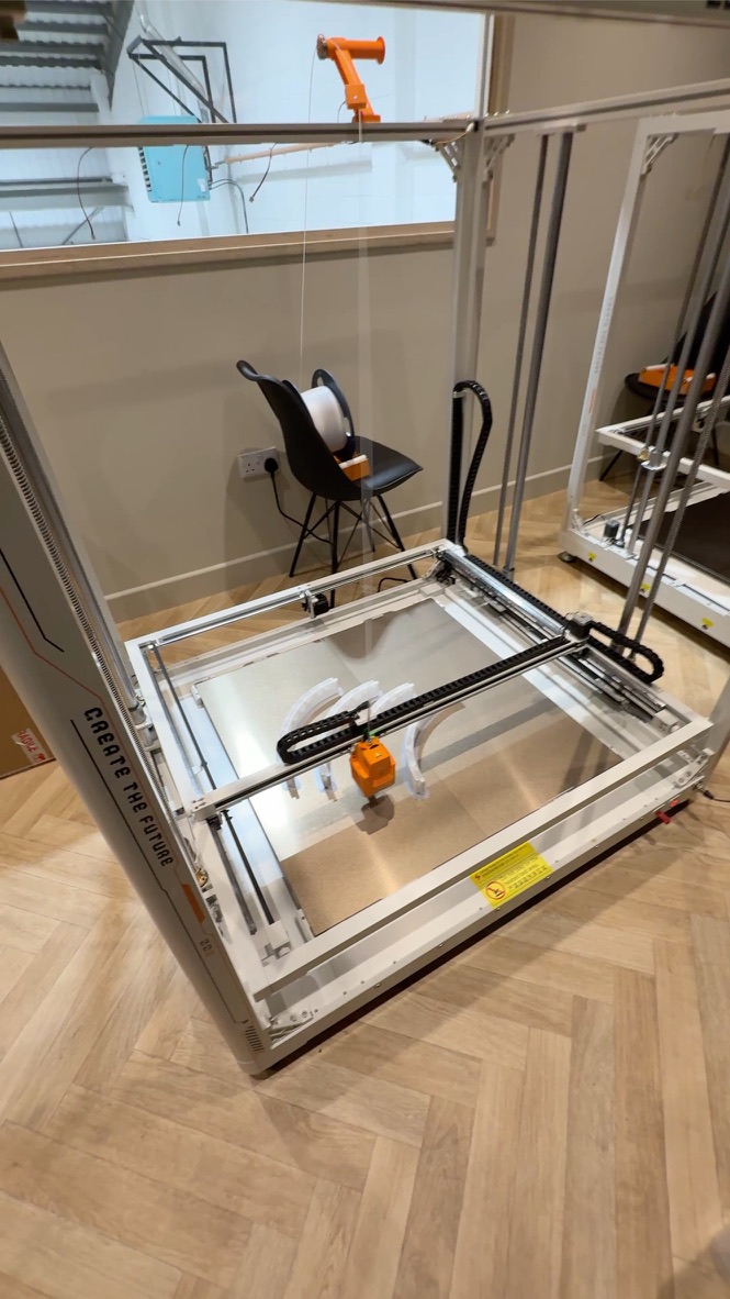 Two large-format Elegoo OrangeStorm Giga 3D printers running in the Premier Woodshop